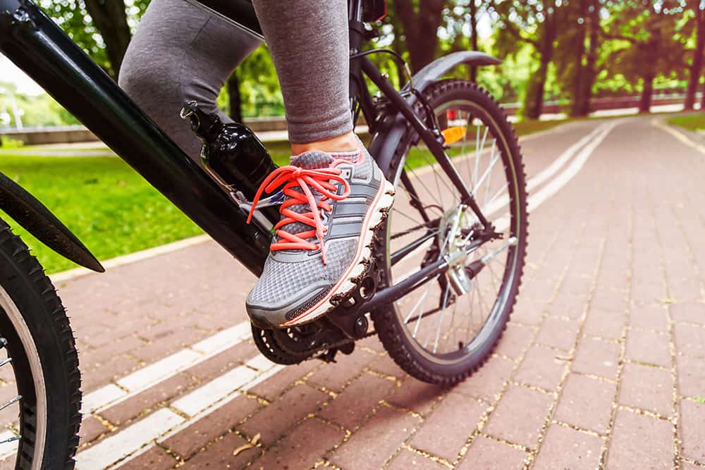 can cycling hurt my hips? woman riding a bike in kansas city